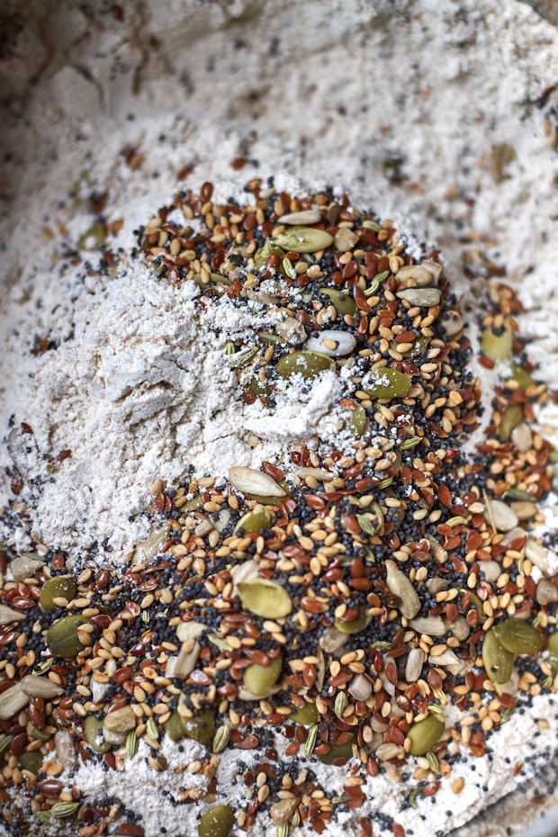 flours and seeds in mixing bowl to make soda bread