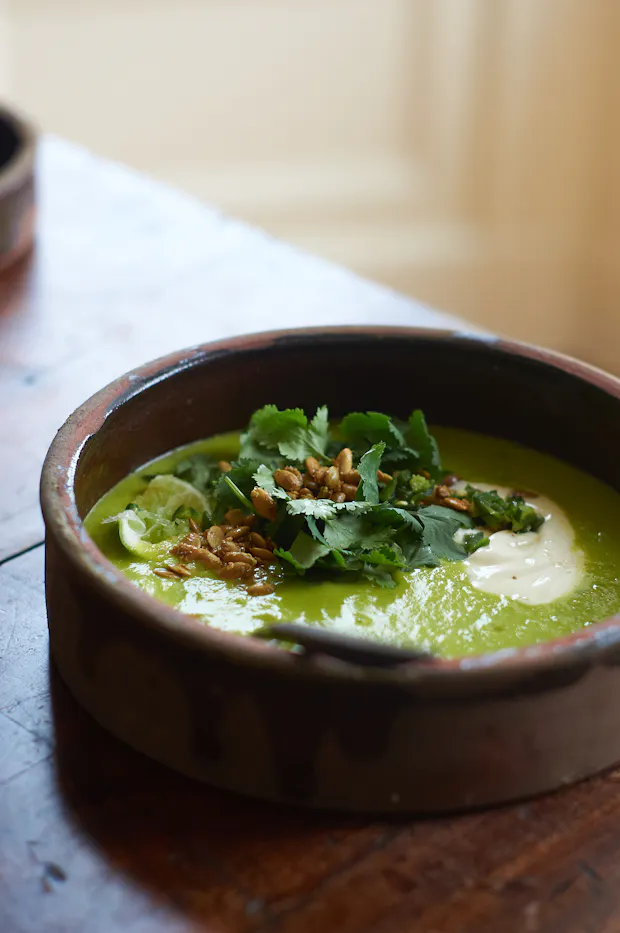 Sopa Verde de Elote soup in a clay bowl