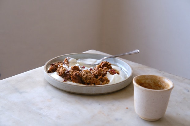 granola served for breakfast at a table with an espresso cup