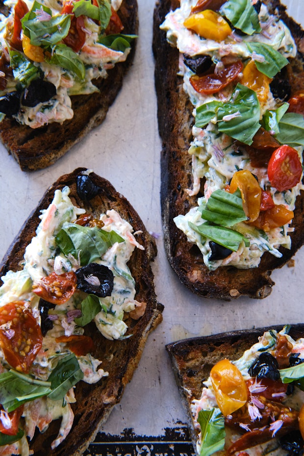 toasted sourdough topped with Greek yogurt and shredded vegetables, olives and roasted tomatoes