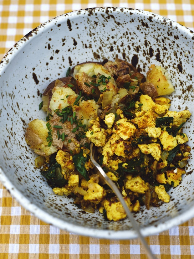 Tofu scrambled eggs in a bowl with fried potatoes