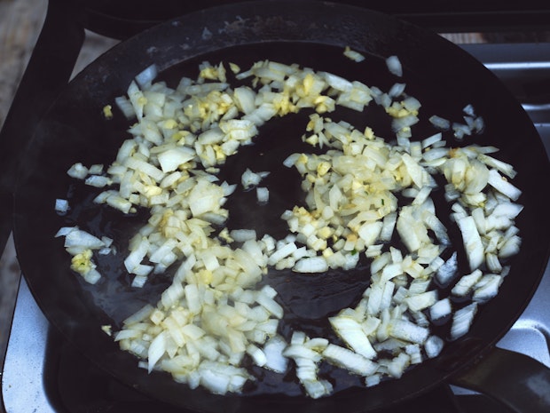 chopped onions and garlic cooking in a large skillet