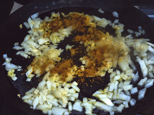 onions, garlic, curry powder cooking in a skillet