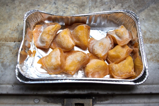 fresh tortelli pasta in a tinfoil container