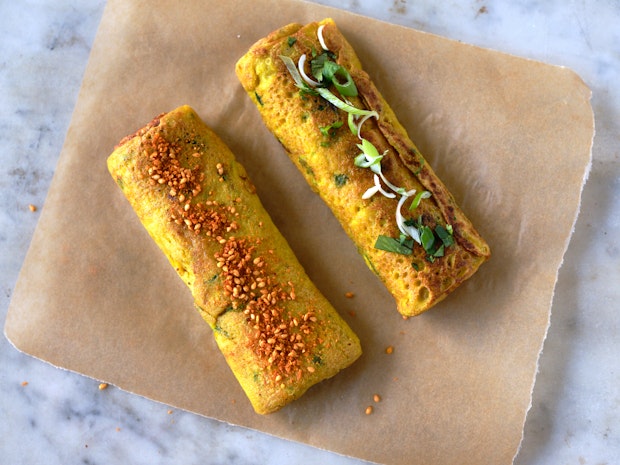 Two vegan tamagoyaki on a cutting board to cool