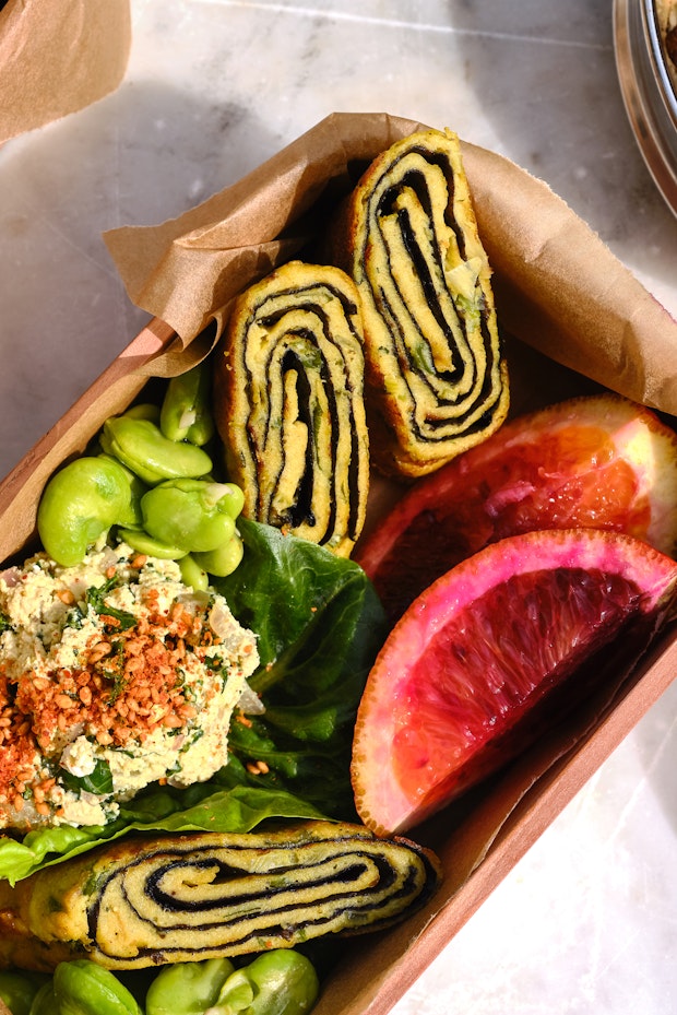 Vegan Tamagoyaki in a Bento Box on a Marble Table