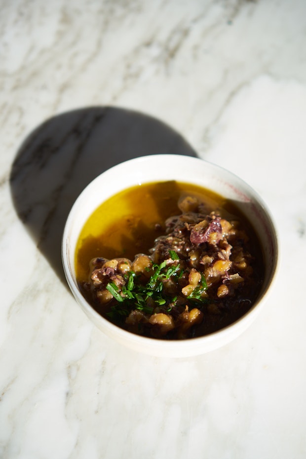 walnut olive miso sauce in a small white bowl on a marble counter
